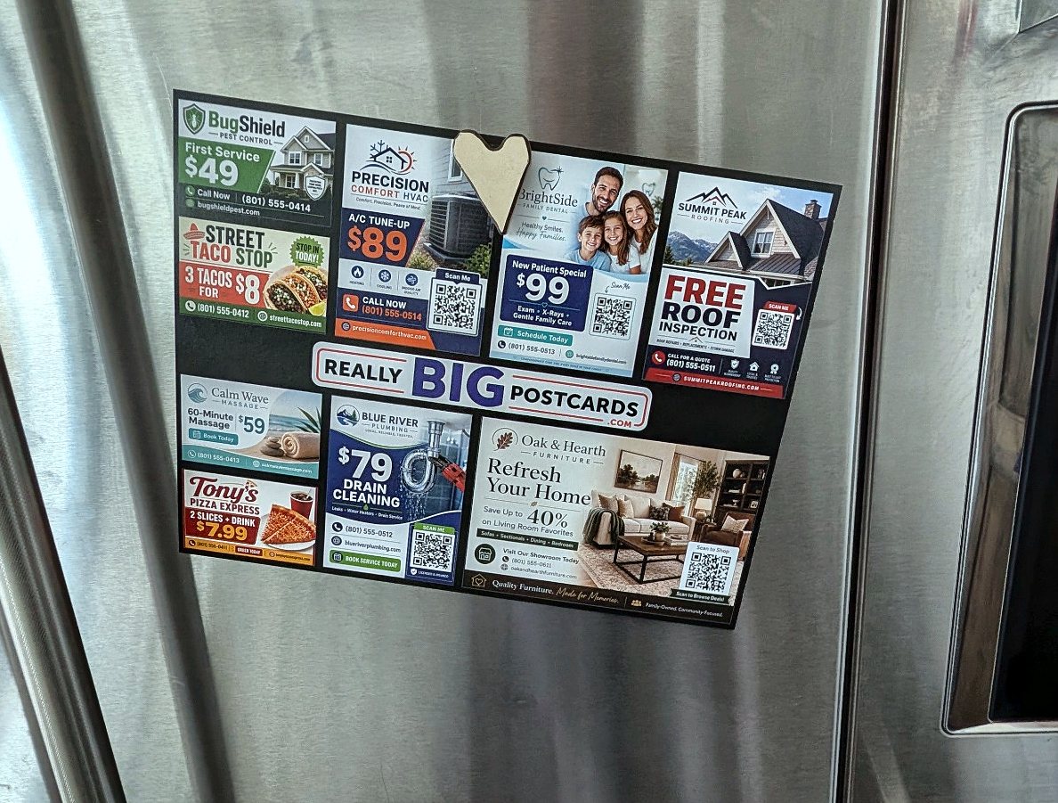 A Really Big Postcard held on a fridge door by a magnet